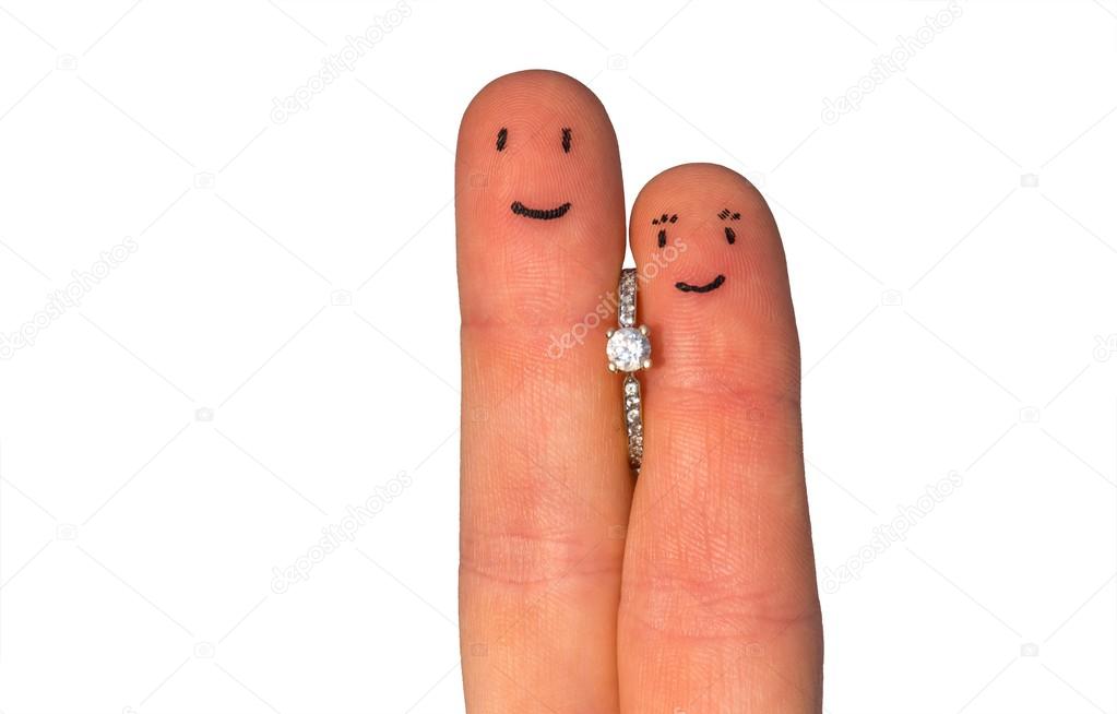 Two fingers with engagement ring