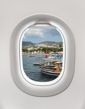 Looking out the window of a plane to the harbor in Bodrum