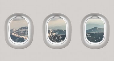 Looking out the windows of a plane to the mountains clipart