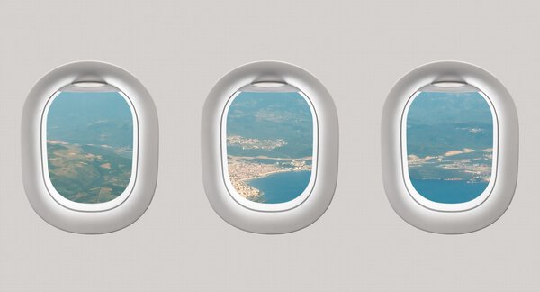 Looking out the windows of a plane to the sea bay