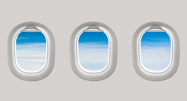 Looking out the windows of a plane to the blue sky and clouds — Stock Photo, Image