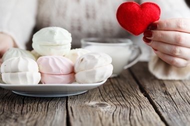 Woman offer red toy heart