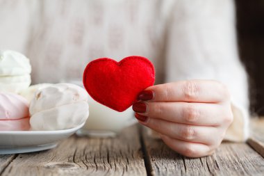 Woman offer red toy heart