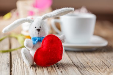 White rabbit and red heart on table
