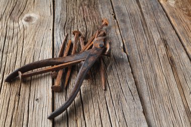 Old nails and clipper on rustic wooden table