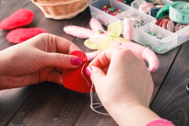 Sewing Process - Women's hands behind her sewing, toy made
