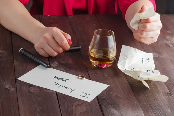 Woman drink alcohol and write message