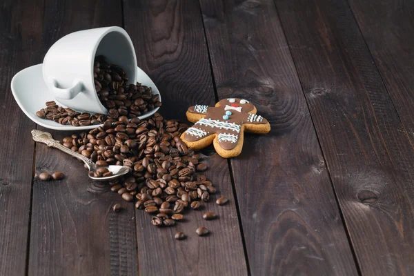 Смажена кавова квасоля в чашці на фоні дерева — стокове фото
