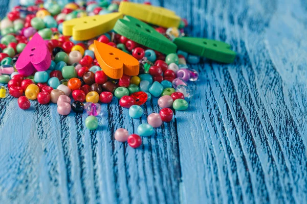 Diferentes grânulos coloridos na mesa de madeira — Fotografia de Stock