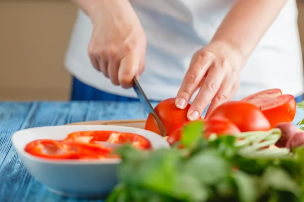 Fechar-se de mulher jovem na cozinha corte de legumes — Fotografia de Stock