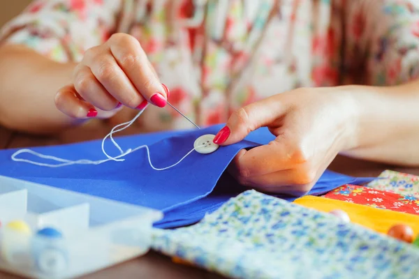 hand for sewing from woman hand