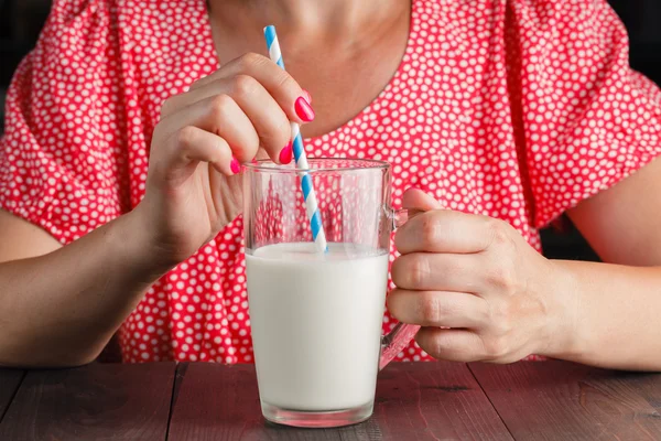 cute woman drinking milk in her kitchen