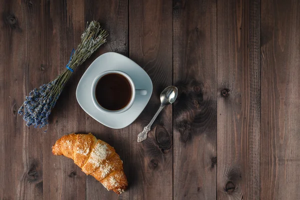 Lavender with coffee on wooden background