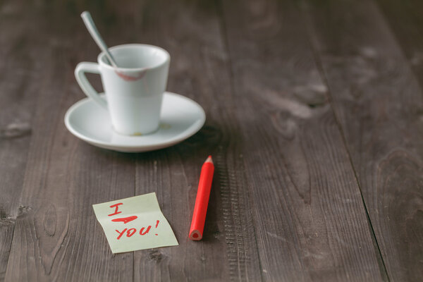 Empty cup of coffee with traces of lipstick on the table