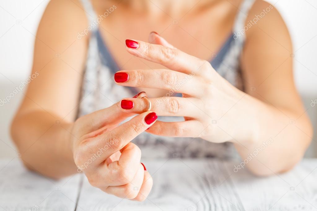 Woman is taking off the ring from hand