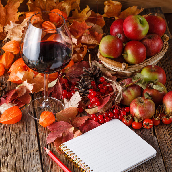 Fall wine in glass on rustic wooden background