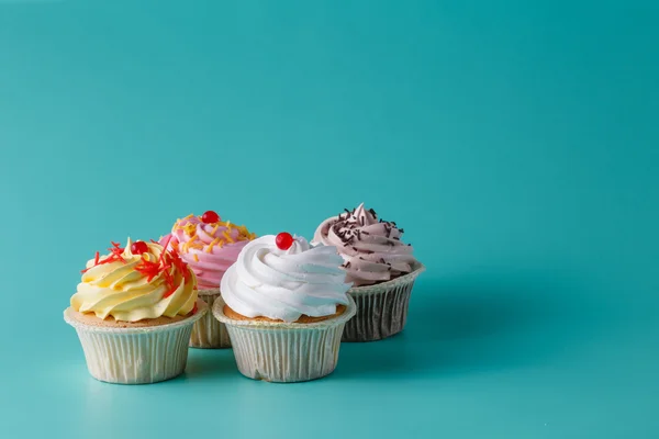 Färgglad rosa cupcake på aquamarine bakgrund — Stockfoto