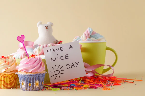 Party decoration. Cupcake with mug and message have a nice day