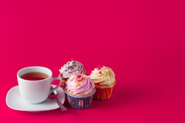 Brigth kırmızı arka plan üzerinde renkli cupcake