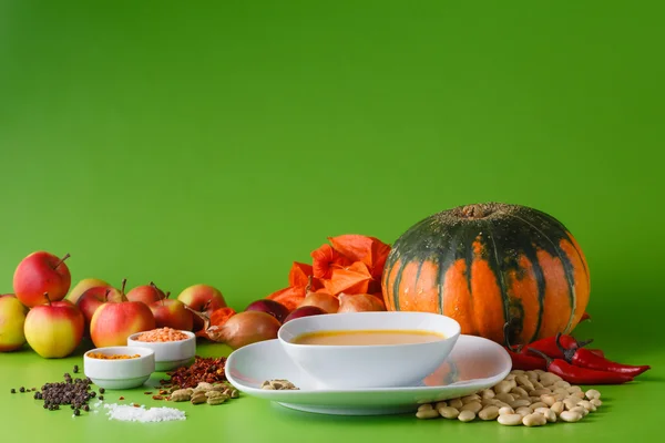 Sopa de calabaza con cebolla y pimienta sobre fondo verde sin sombra — Foto de Stock