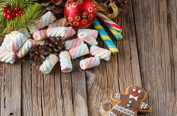 Christmas theme. Pine and red ball on wooden table — Stock Photo, Image