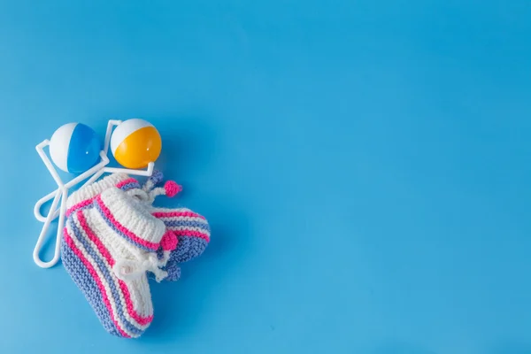 Rattle for the newborn on blue background — Stock Photo, Image