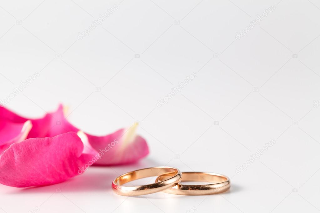 Rose petals and gold wedding rings