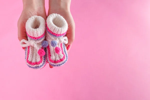Femme tenir minuscules bottines nouveau-né — Photo