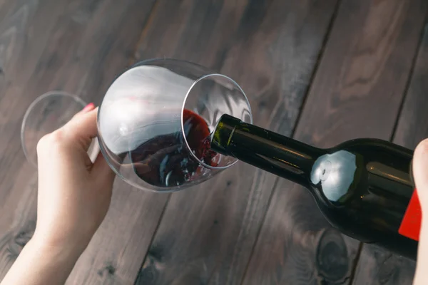 Alcoholic woman is pouring wine — Stock Photo, Image