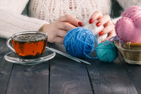 Beautiful girl in a white dress hand knitting with a cup of tea — Stock Photo, Image