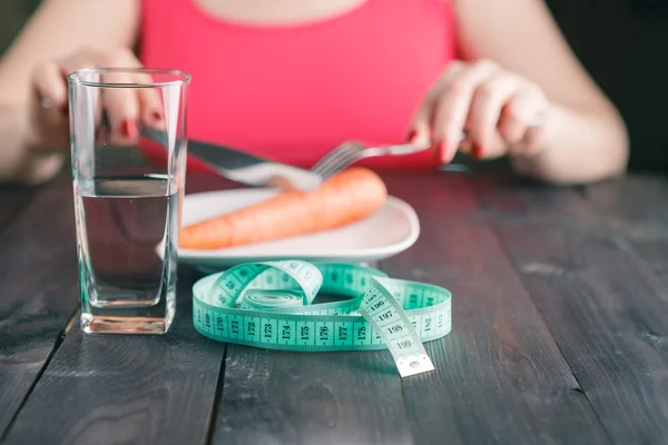 Wanita yang sedang diet dan makan wortel di dapur — Stok Foto