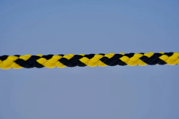 Black and yellow rope to prevent people from passing into insecure terrain at Jungfraujoch, Switzerland.
