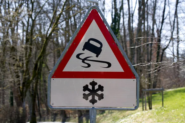 Road sign warning slippery road ahead in case of snowfall. Photo taken March 31st, 2021, Dbendorf, Switzerland.