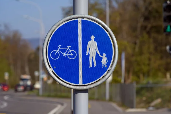 Road sign for divided bicycle and pedestrian lane. Photo taken April 21st, 2021, Zurich, Switzerland.