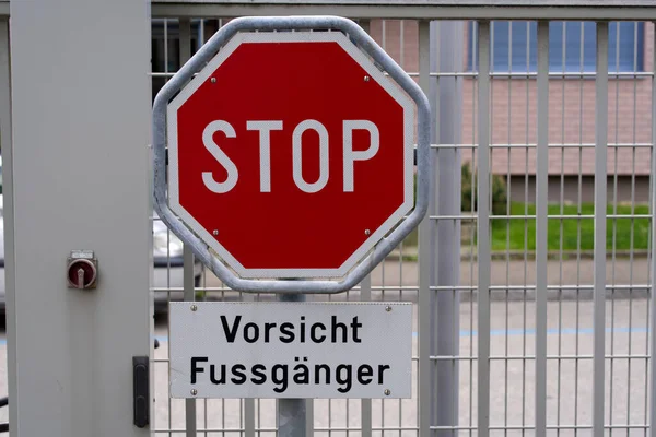 Stop traffic sign with text Vorsicht Fussgnger (German, translation is watch out for pedestrians). Photo taken May 19th, 2021, Zurich, Switzerland.