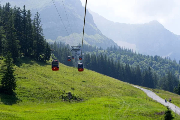 Red cable car at Mountain Pilatus on a cloudy summer day morning. Photo taken July 23rd, 2021, Alpnach, Switzerland.