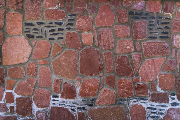 Kırmızı Taş Masonlu Duvar Doku Örnekleri Arkaplanı. Harç eklemleri ve koyu eklemli, mimari doku arka planı olarak ideal kırmızı taştan bir duvarın tam çerçeve görüntüsü