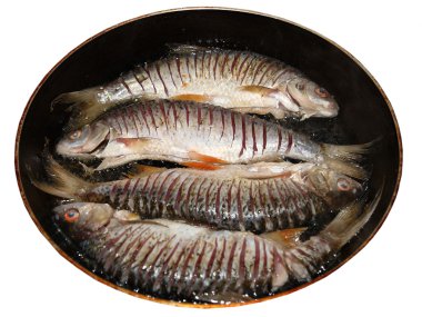 Cooking pan-fried fresh fish. clipart
