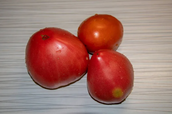 Three large tomatoes on the table. — Stock Photo, Image