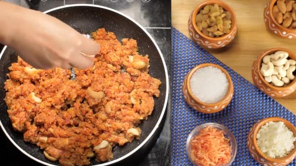 インドの甘い デザートの準備のためのすりおろしたニンジンの料理 ニンジン ガジャール ハルワ 伝統的なガジャール ハルワ料理で女性の手を振りかけるドライコヤ マワのクローズアップ — ストック動画