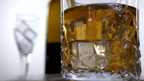 Rotating Crystal Glass Golden Whiskey Big Ice Cubes Filled Extreme — Vídeos de Stock