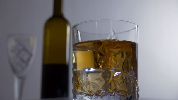 Beautiful View Rotating Glass Whiskey Filled Big Ice Cubes Closeup — Vídeos de Stock