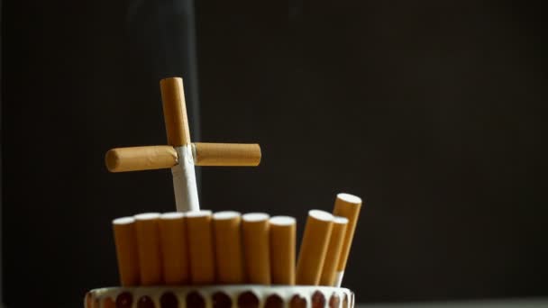 タバコの喫煙の危険性を撮影クロス 反タバコのキャンペーン 有毒ガスを放出するタバコのクローズアップショット 死を象徴する — ストック動画
