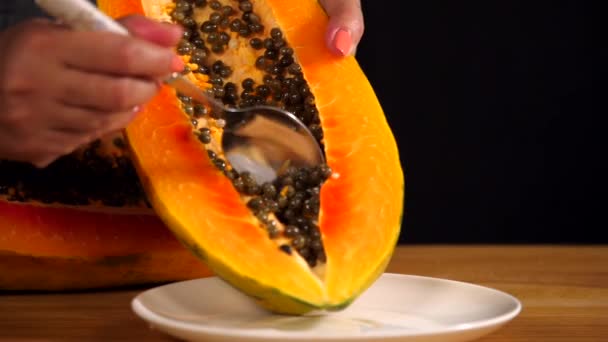 Woman Hand Using Spoon Scoop Out Black Seeds Freshly Cut — Stock Video