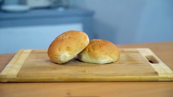 Close Shot Two Slices Burger Bun Sesame Seeds Kept Kitchen — Stock Video