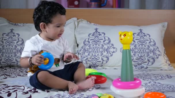 Cute Indian Baby Girl Black Hair Playing Colorful Plastic Toys — Stock Video