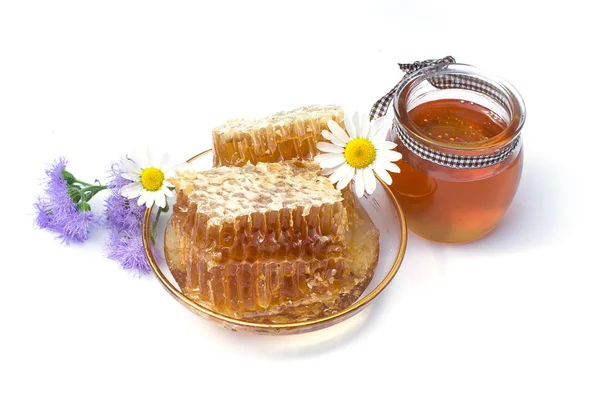 Honeycomb, chamomile, honey in a glass jar on a white background — Stock Photo, Image