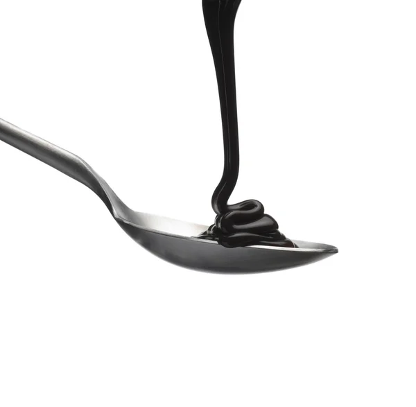 Chocolate flowing onto a spoon — Stock Photo, Image