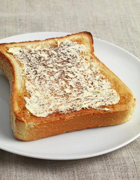 Toast with butter on plate — Stock Photo, Image