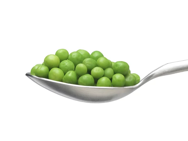 Green peas on a silver spoon — Stock Photo, Image